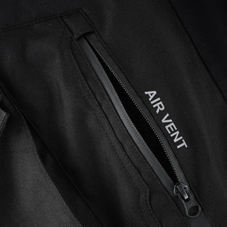 Close-up of a zippered 'AIR VENT' opening on the textile trousers, showing the zipper and pull tab partially opened to expose the internal mesh or venting material.