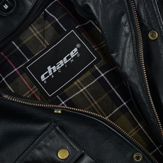 Close-up of the open leather jacket interior, showing the branded Chace Racing patch tag against a classic olive green and black tartan plaid lining.