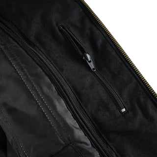 Close-up view of the interior lining of the black jacket, showing two separate, zippered security pockets built into the fabric for secure storage.