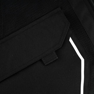 Close-up of the jacket's lower cargo pocket flap, showing the woven pull-tab for opening and a small portion of the white reflective trim on the side.