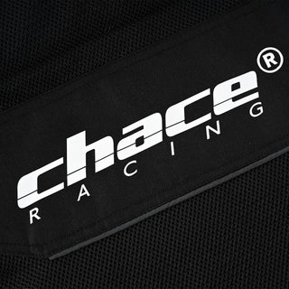 Close-up of the jacket's mid-torso, showing the white "Chace Racing" brand logo patch centered over the black hexagonal mesh panel.