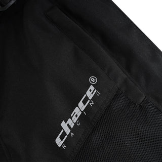 Close-up of the trouser's upper thigh, showing the "Chace Racing" logo adjacent to the black textile and the underlying breathable mesh panel.