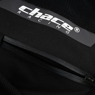 Close-up showing the "Chace Racing" brand patch positioned directly above a partially unzipped black closure, which could be an inner pocket or a vent opening.