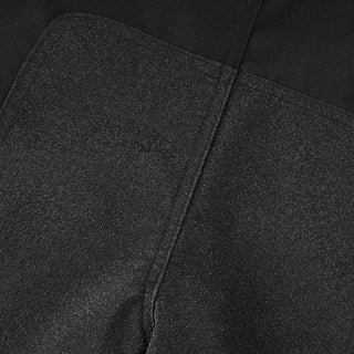 Extreme close-up of a dark, textured, abrasion-resistant panel (likely non-slip or reinforced textile) integrated into the trousers, showing the rough, durable surface.