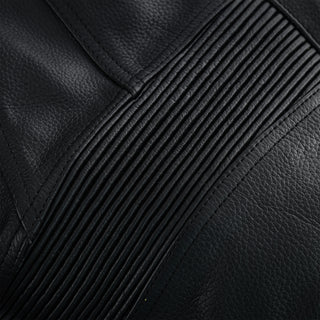 Extreme close-up of the black leather material, highlighting the finely stitched, multi-line accordion stretch panel, positioned for knee or lumbar flexibility.