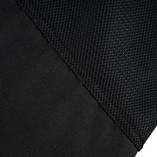 Close-up showing the clear diagonal dividing line between the durable, solid black textile material and the black, breathable, perforated mesh panel.