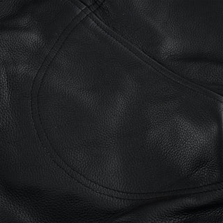 Extreme close-up of the smooth black leather, showing a large, curved panel with double-row stitching, designed to reinforce the motorcycle trousers' seat area.