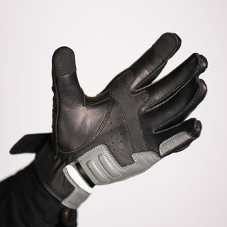 Palm view of the Stratus glove with fingers fully extended, showing the leather palm, grey protective/reinforcement panels, and perforated areas for ventilation.