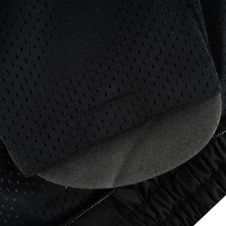 Close-up of the interior showing the gray protective foam pad partially visible inside the armor pocket, set within the black perforated mesh lining.