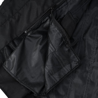 Close-up of the jacket's interior showing a large, zippered patch pocket built into the lining for secure storage, with a small flap of material lifted to show the opening.