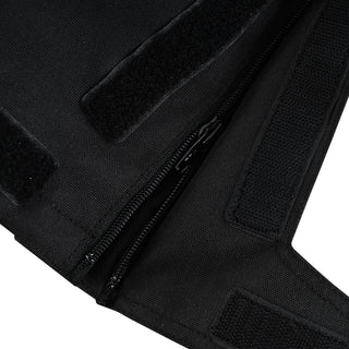 Extreme close-up of the trousers' lower leg, showing the durable zipper and the wide hook-and-loop (Velcro) panels used to adjust the leg opening over riding boots.