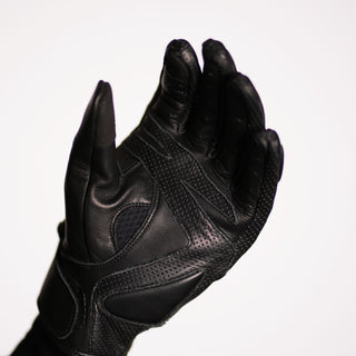 Palm view of the black leather glove with fingers slightly curled, showcasing the perforated and breathable mesh panels between the leather reinforcement for ventilation.