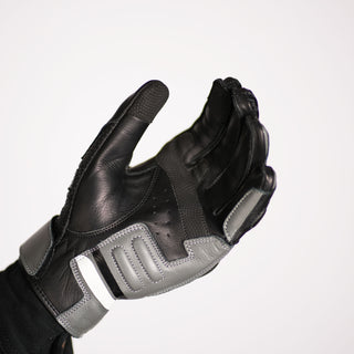 Palm view of the glove being worn with fingers slightly curled, highlighting the reinforced grey leather pad on the heel of the hand/palm base.