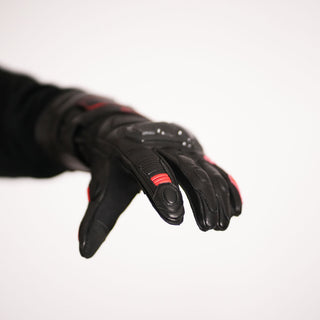 Palm view of the glove being worn with fingers extended, showing the smooth leather palm, perforated leather panels, and red reinforcement in the finger/palm area.