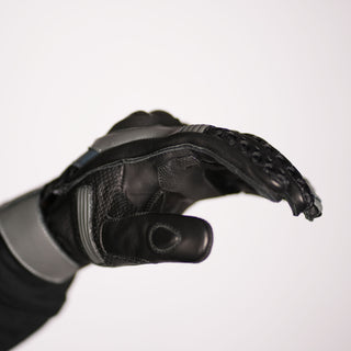 Side profile of the Stratus glove, emphasizing the smooth leather thumb, the layered mesh/leather construction, and the overall technical design of the back of the hand.