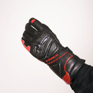 The black and red Terra racing glove is shown flexed into a riding grip, emphasizing the carbon fiber knuckle protector, finger articulation, and the Chace Racing logo on the wrist gauntlet.